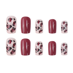 Short press-on nail kit featuring deep red glossy finish and leopard pattern design