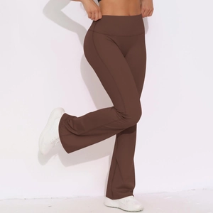 Macro shot of high-waist yoga flared pants in dark brown fabric with shaping effect