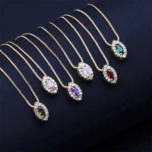 Detail view of gold-plated box chains with colorful oval zircon teardrop pendants