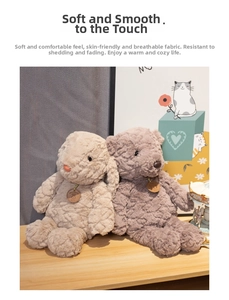 Close-up of soft plush bear and rabbit dolls in beige and purple on a wooden table