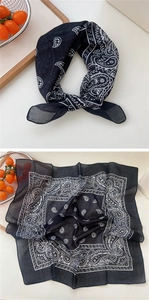 Detailed close-up of a black cotton linen paisley bandana with classic square patterns