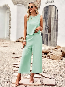 Detail of mint green sleeveless top and wide-leg pants in cotton-linen fabric