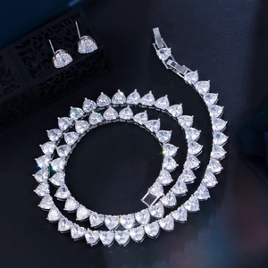 Macro detail of sparkling heart-shaped zircon necklace and matching earrings set