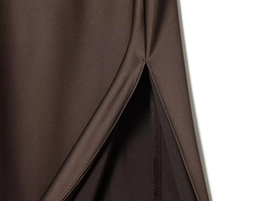 Detail of the high-quality stitching and slit design on a brown satin maxi dress