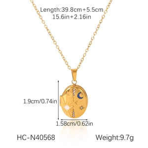 Detail view of gold oval locket necklace with star moon pattern and size measurements