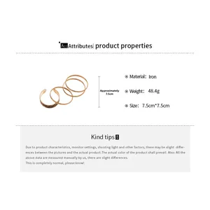 Detail view of four-piece gold iron bangles with hammered texture and 7.5cm diameter