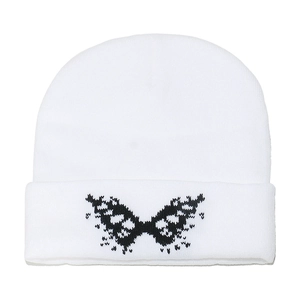 White knitted beanie with black butterfly jacquard pattern and folded cuff design