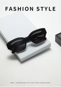 Detail view of black TR90 polarized sunglasses on white minimalist geometric display blocks