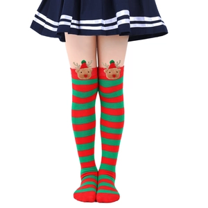 Close-up of festive red and green striped Christmas knee-high socks with 3D reindeer doll