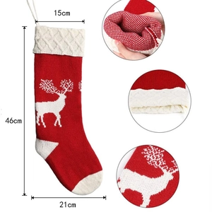 Red and white knitted Christmas stocking with reindeer patterns and size dimensions