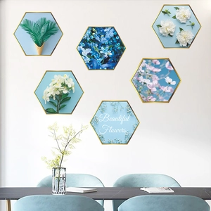 Modern hexagonal wall art set with gold frames and floral botanical prints in light blue