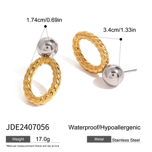 Detail of mixed-tone stainless steel drop earrings with gold twist and silver sphere
