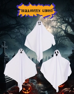 Detailed view of three hanging fabric white ghosts with black facial expressions for Halloween