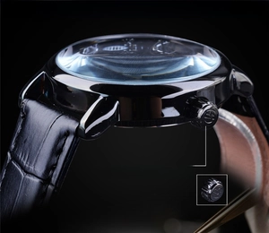 Macro side view of polished black stainless steel case and crocodile leather strap