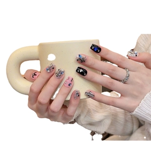 Black and pink press-on nails with chrome heart crosses and sapphire heart rhinestones