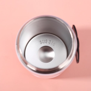 Macro detail of high-quality SUS 316 stainless steel interior on a pink thermal cup
