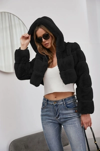 Detail of short black faux fur hooded coat with soft texture and premium stitching
