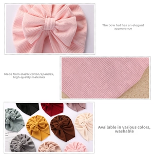 Detailed close-up of waffle texture fabric and bow design on solid infant turban hats