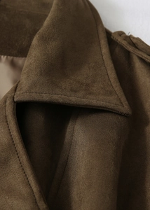 Gros plan du col de manteau en daim synthétique marron foncé avec coutures doubles