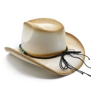 Close-up of hand-woven straw cowboy hat with turquoise beads and brown spray-painted edges