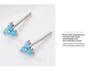 Detailed macro view of S925 sterling silver stud earrings with three blue turquoise stones
