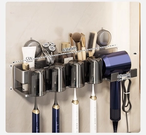 Detailed view of grey wall-mounted toothbrush rack with cups and hair dryer holder