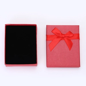 Classic red paper gift box with ribbon bow and black velvet lining for jewelry storage