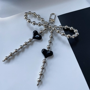 Beaded bow keychain with black heart charms and silver metallic beads for handbags