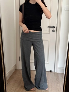 Detail showing the double-layered fold-over waistband on slim-fit knitted trousers