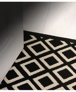 Detail shot showing the ultra-thin geometric door mat not obstructing the door frame opening