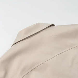 Detailed back view of the beige turn-down collar and shoulder stitching on a jacket
