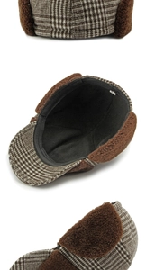 Detail of brown plaid trapper hat with soft faux fur lining and size label detail