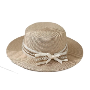 Flat top straw sun hat for women with lace ribbon and side silk bow detail