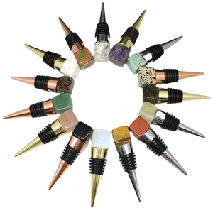 Set of 16 natural crystal cube wine stoppers with metallic base in a circular layout