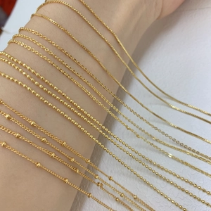 Dettaglio di varie catene in rame placcato oro 18k con diversi stili di maglia e perline