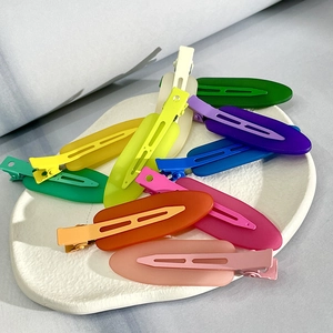 Matte non-marking hair clips in assorted colors displayed on a white textured plate