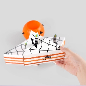 Halloween triangular cake-shaped treat box with spider web pattern and candle topper