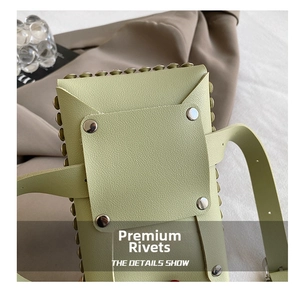 Close-up of lime green leather bag with silver rivet details and fine texture