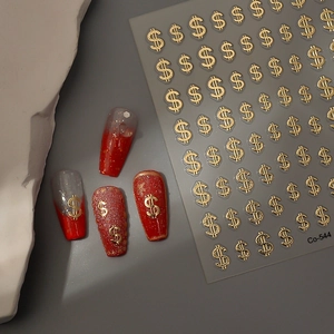 Macro detail of Co-544 gold 3D dollar sign nail stickers on red gradient manicure