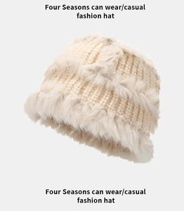 Detailed view of the beige rabbit fur knit hat showing plush texture and layered trim