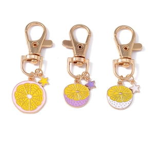 Three creative enamel lemon and star pendants on gold lobster clasp keychains for bags