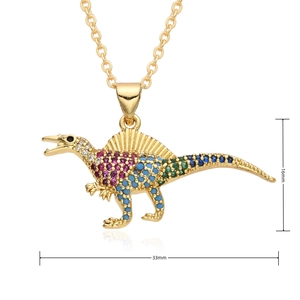 Macro shot of gold-plated dinosaur pendant with colorful zircons showing 33mm x 16mm size