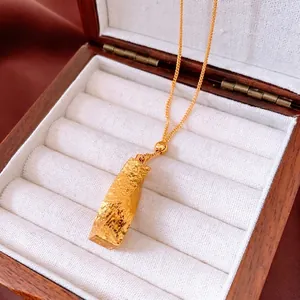 Vintage 24k gold plated rectangular pendant necklace with textured finish on display box