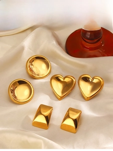 Dettaglio di tre orecchini placcati in oro 18K con forme a cuore, cerchio e rettangolo
