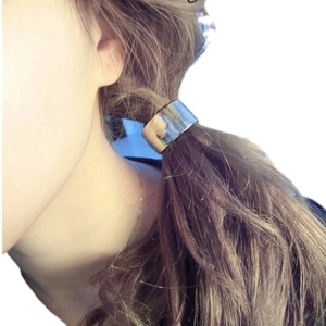 Minimalist silver metal hair cuff hair tie shown on a ponytail from a side view