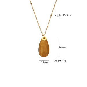 Detail showing the size and weight of teardrop tiger eye pendant with golden chain