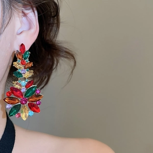 Close-up of vibrant crystal flower drop earrings with colorful rhinestones on a model