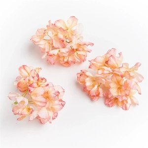 Detailed view of pink and orange artificial hydrangea petals with burnt edge effect