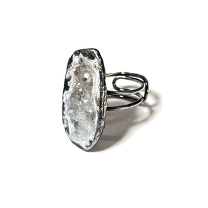 Detailed macro of a vintage geode crystal ring with antique silver soldered band
