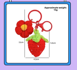 Handmade crochet strawberry keychain with red flower details and exact dimensions